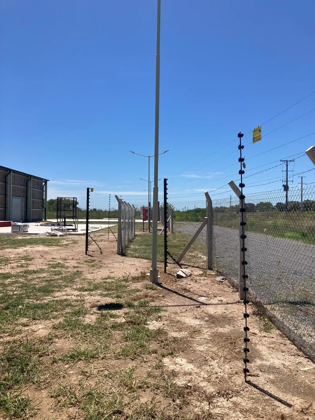 Cerco eléctrico sobre muro y portón en el acceso a un predio