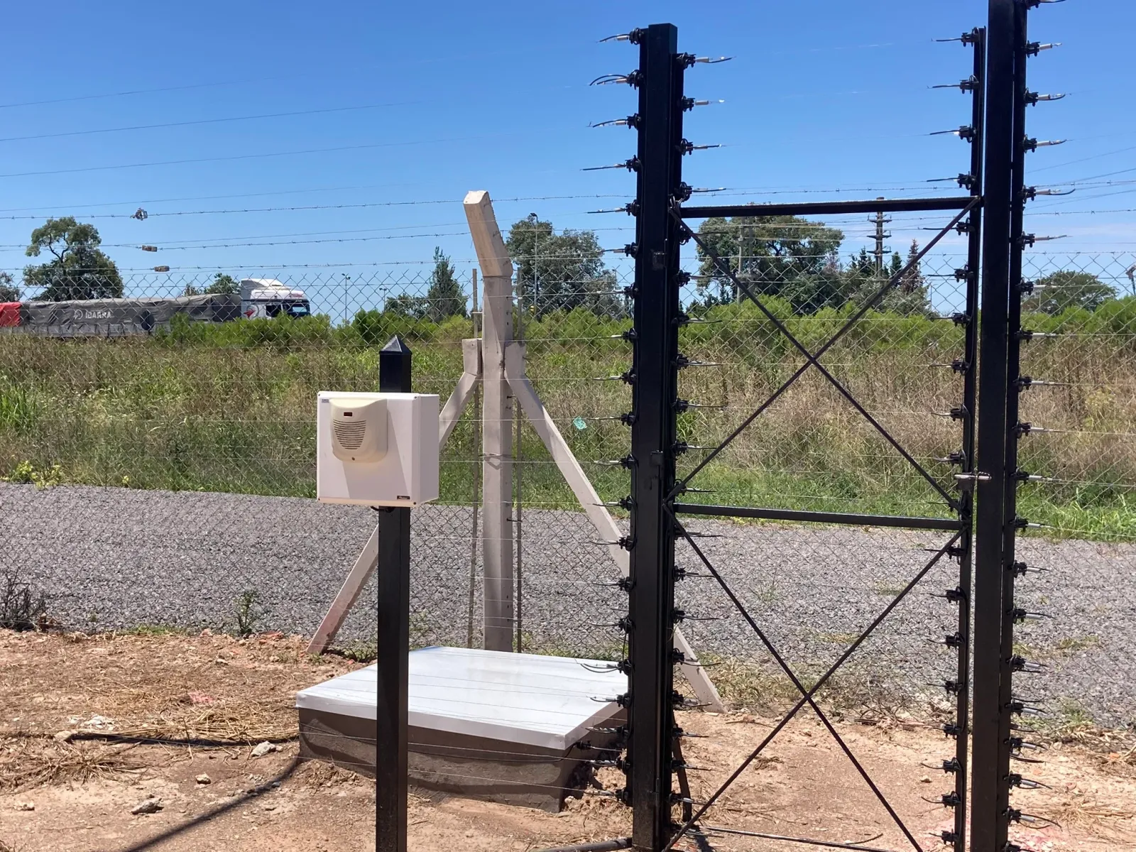 Cerco eléctrico y central en el acceso de un predio sobre ruta